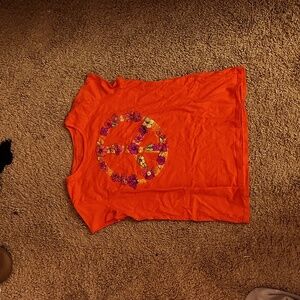 Reddish orange tee with floral peace sign design